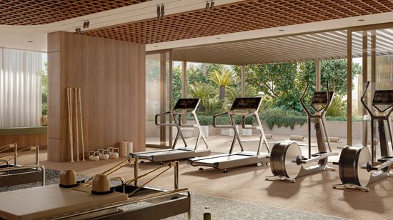 An artist’s impression of the gym and outdoor yoga area at SOL by Walker, with several treadmills and cycling machines looking out towards the full-height glass doors.