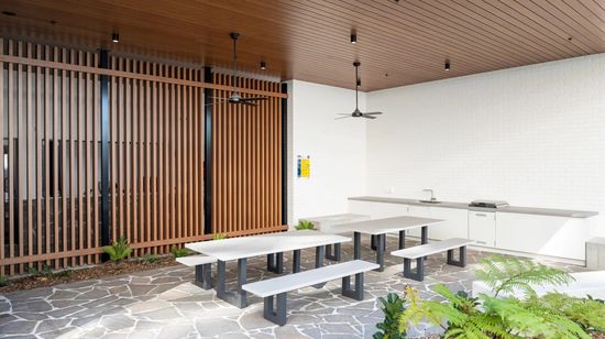 A seating area with a shared barbecue and counterspace in a residents’ area at The Corso.